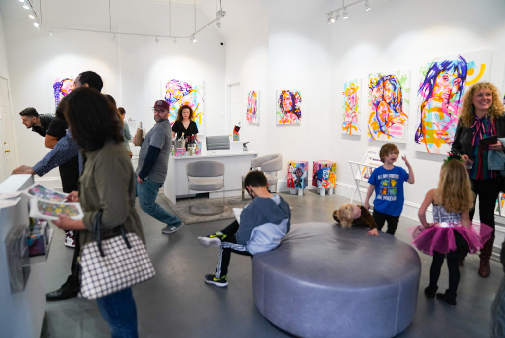 Photograph of people and kids during The Tracy Piper's Bloom exhibition Opening Reception at Voss Gallery, San Francisco, March 18, 2022.