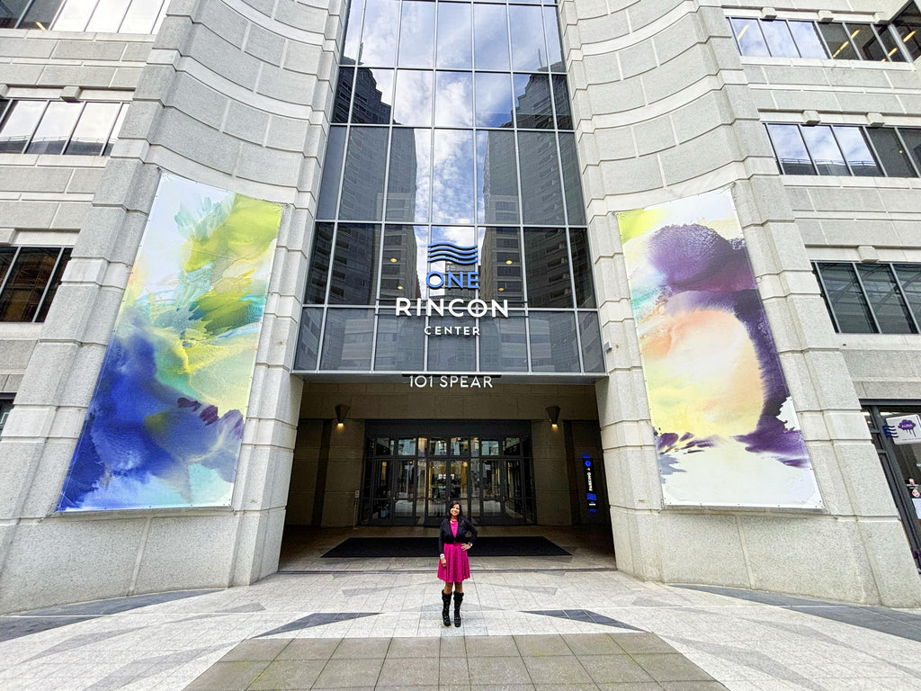 Usha Shukla's large-scale abstract banners displayed at Rincon Center, presented by Voss Gallery in 2024, showcasing vibrant color transitions and fluid shapes that capture the lively essence of San Francisco's contemporary art scene.