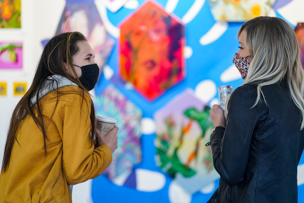 Photograph of two women with face masks talking during the Paradise group exhibition VIP Collectors Event at Voss Gallery, San Francisco, April 2021.