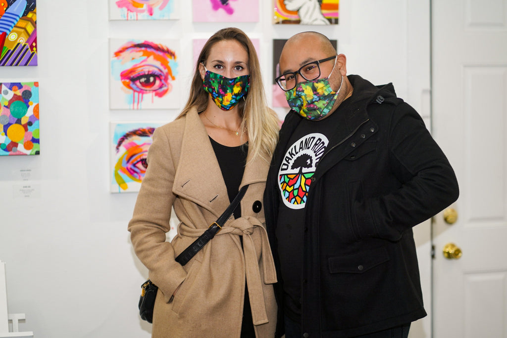 Photograph of two people wearing floral face masks during the "It's BASL, Baby!" group exhibition VIP Young Collectors Event at Voss Gallery, San Francisco, December 4, 2020.