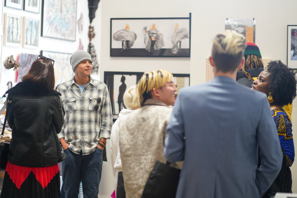 Photograph of collectors and guests during the 'Art Unveiled: Collectors Mixer' at Voss Collector Club's visit to 1890 Bryant Studios, San Francisco, on March 10th, 2024.