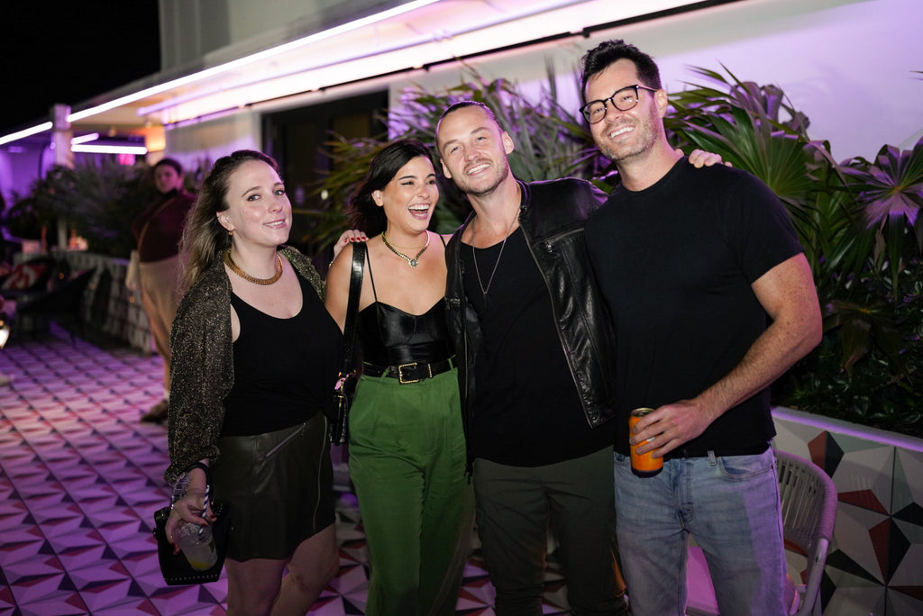 Photograph of four people attending the Moxy Afterparty Art Basel Event in Miami Beach, December 2023.