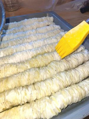 Brush the remaining butter on top of the baklava rolls.