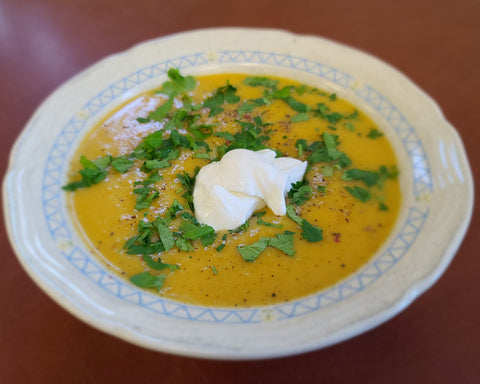 A tasty bowl of butternut squash soup made with maple syrup.