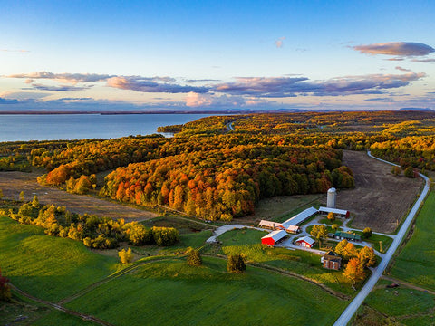 Drone shot of the Carman Brook Farm and the Missisquoi Bay in full fall foliage.