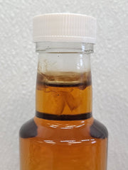 Mold growing on a bottle of maple syrup.