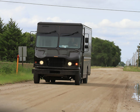 UPS truck trekking the backroads to make deliveries and pickups.