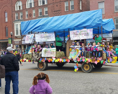 The Girl Scouts on their maple festival parade float.