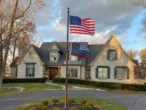 american flagpole display outside a home