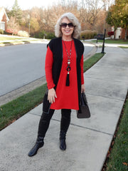 A woman wearing Black boots and red dress