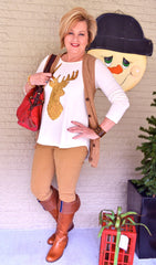 A woman in brown boots holding her red bagg
