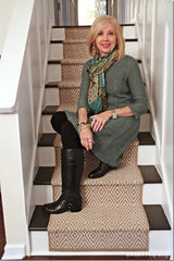 Photo of a woman sitting in the stairs wearing black boots