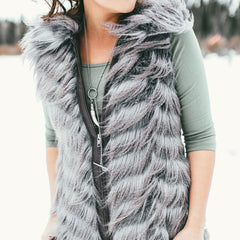 Photo of a woman in a feather vest