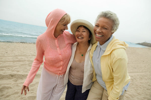 Three woman laughing at the beach