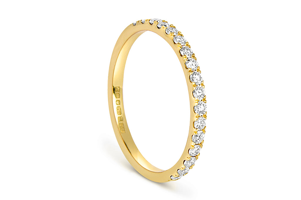 The half microset Altair eternity wedding band, cast in 18ct yellow Fairtrade Gold and set with conflict-free Canadian diamonds