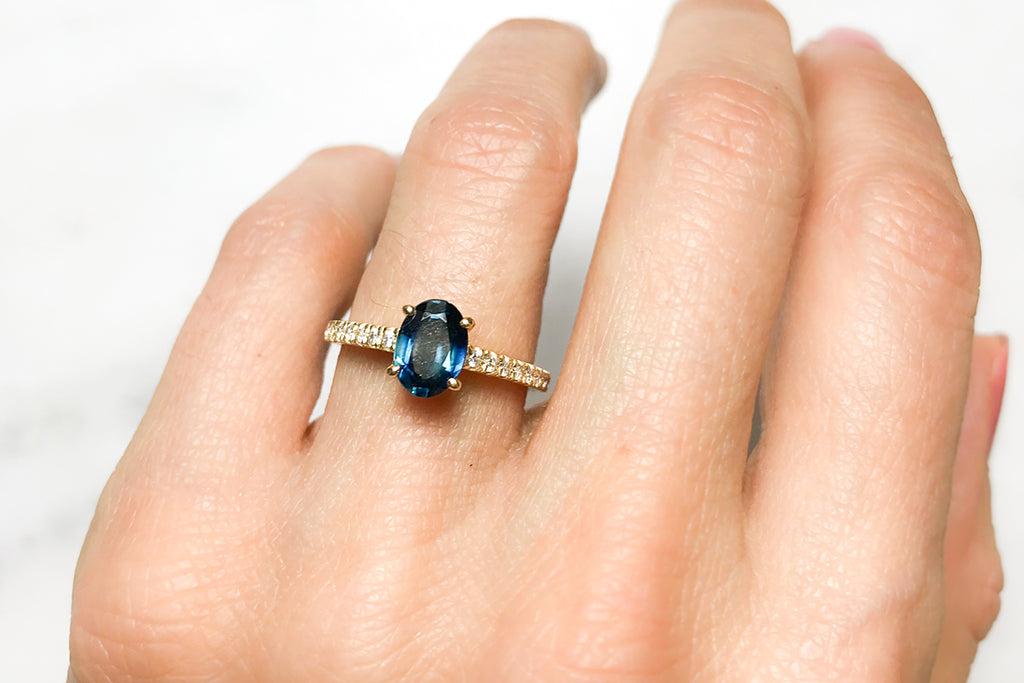 Our Cybele oval-cut sapphire engagement ring with pave set conflict-free diamonds in the recycled gold band