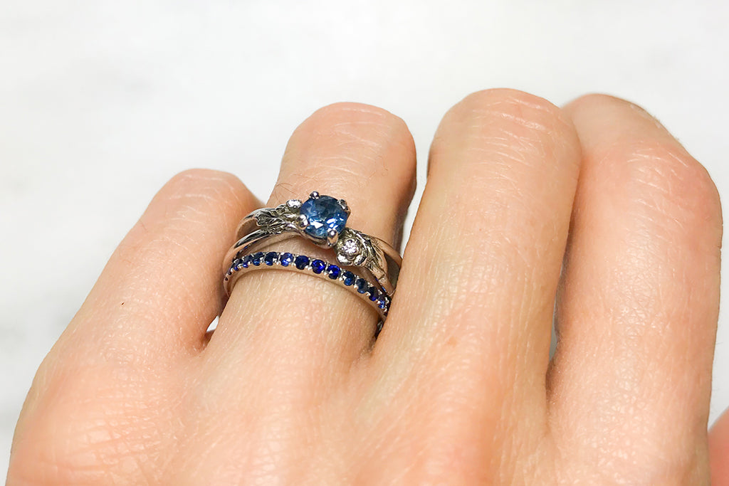 Nature-inspired Foliage engagement ring and microset Altair eternity wedding band, both cast in 100% recycled platinum and set with traceable and fair-traded blue Sri Lankan sapphries