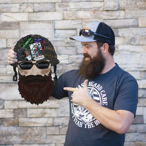 man with clean beard pointing at a picture of a man with a beard