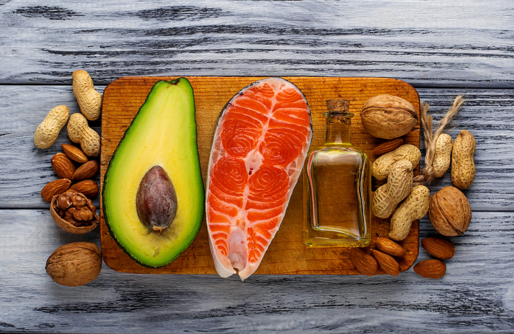 Healthy fats including avocado, salmon, cashews and almonds