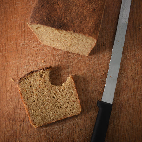 wholegrain sourdough loaf sliced with a bite taken out