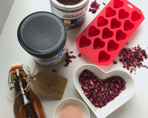Ingredients needed to make homemade chocolates include vanilla, cocoa, coconut oil, salt, silicone mold and rose petals.