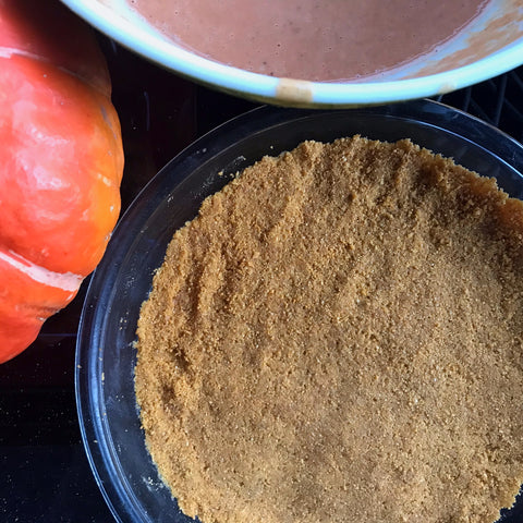 A graham cracker crust, ready to be filled with pumpkin pie filling. 