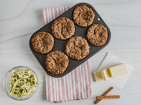 Keto zucchini muffins with stick of butter and shredded zucchini