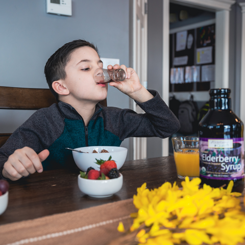 elderberry syrup taken by a young boy