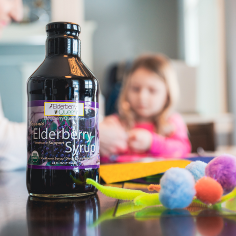 organic elderberry syrup and a kiddo doing homework at the table