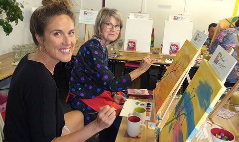 Happy women enjoying a step by step painting class in the Heart for Art studio