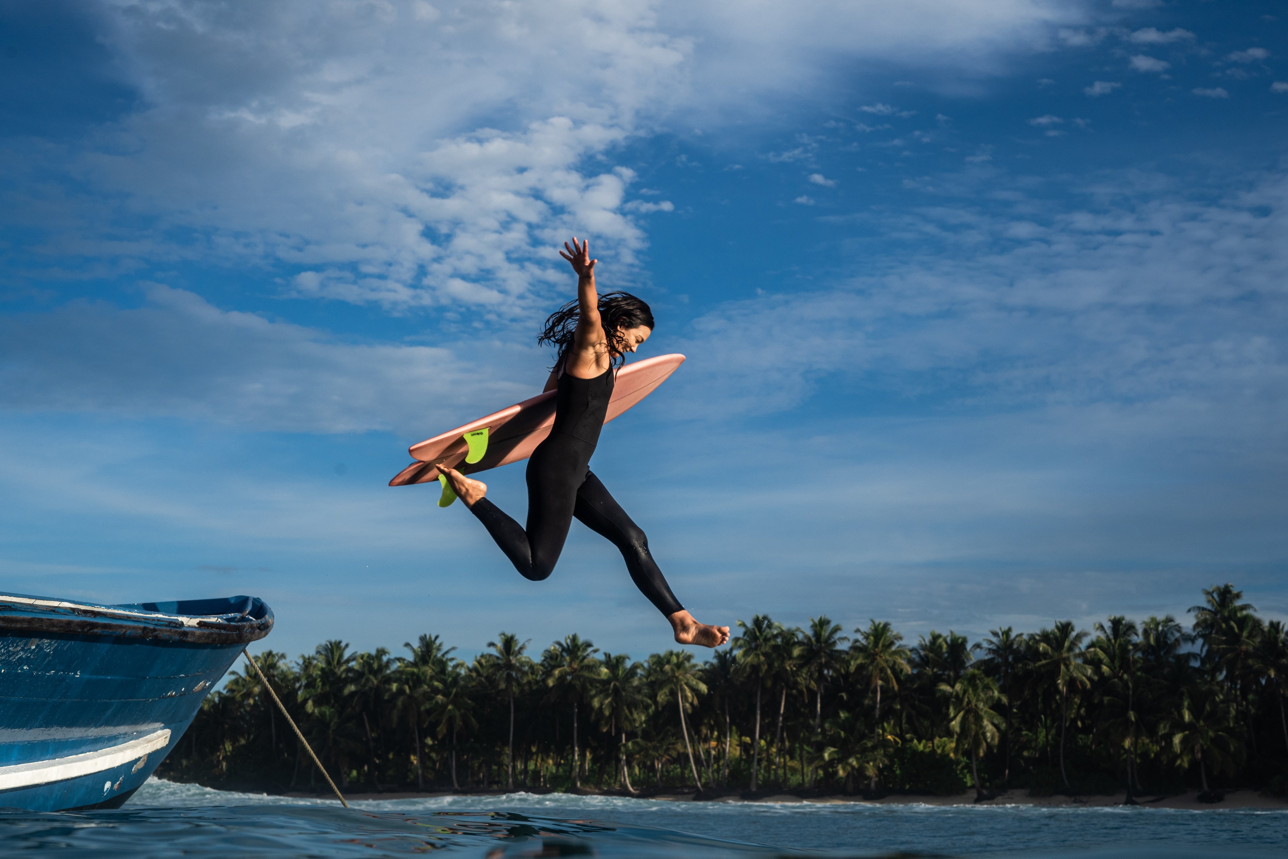 Seea surfer Rosie Jaffurs jumps off the boat into the ocean for a surf in the Mentawai Islands