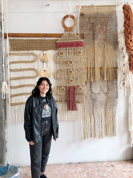 Daniela Chiñas' in front of her work in her Mexico City studio