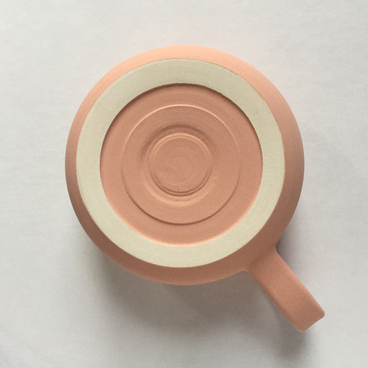 Two toned, peach matte with heathered glaze mug, bottom view