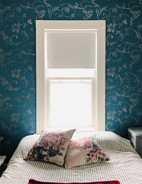 Flourish wall stencil on a teal blue bedroom wall
