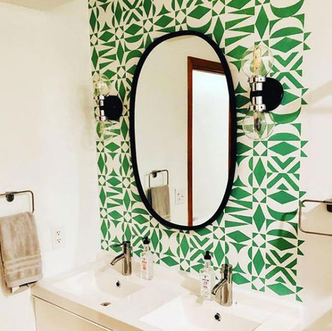 Opposites Attract wall stencil Royal Design studio on bathroom wall in shades of green