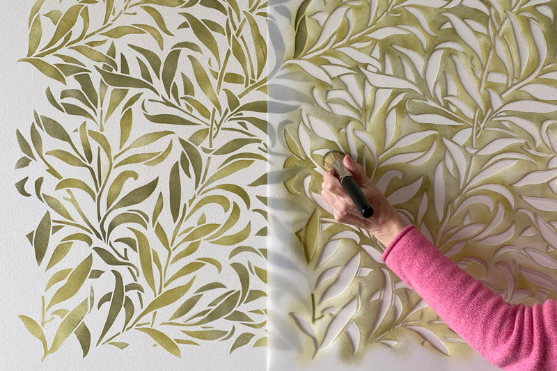Stenciling a wall with stencil brush and paint