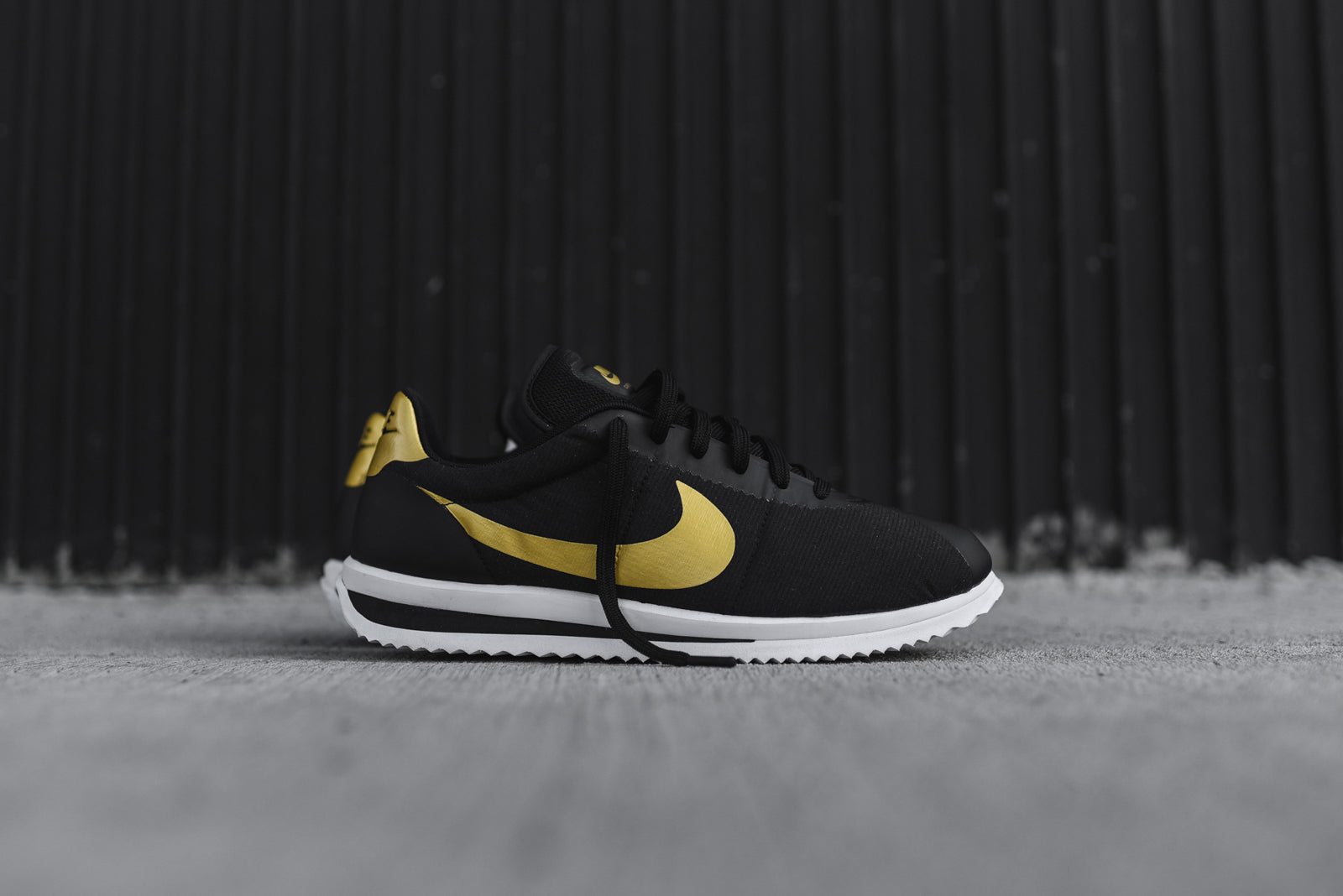 nike cortez ultra black gold