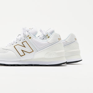 new balance gold and white