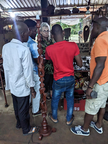 Binky Newman surrounded by salesmen FEIMA market, Maputo, Mocambique