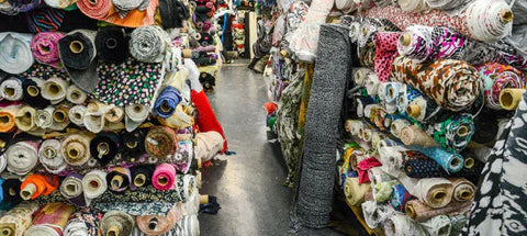 warehouse full of rolls of deadstock fabric - sustainable fashion