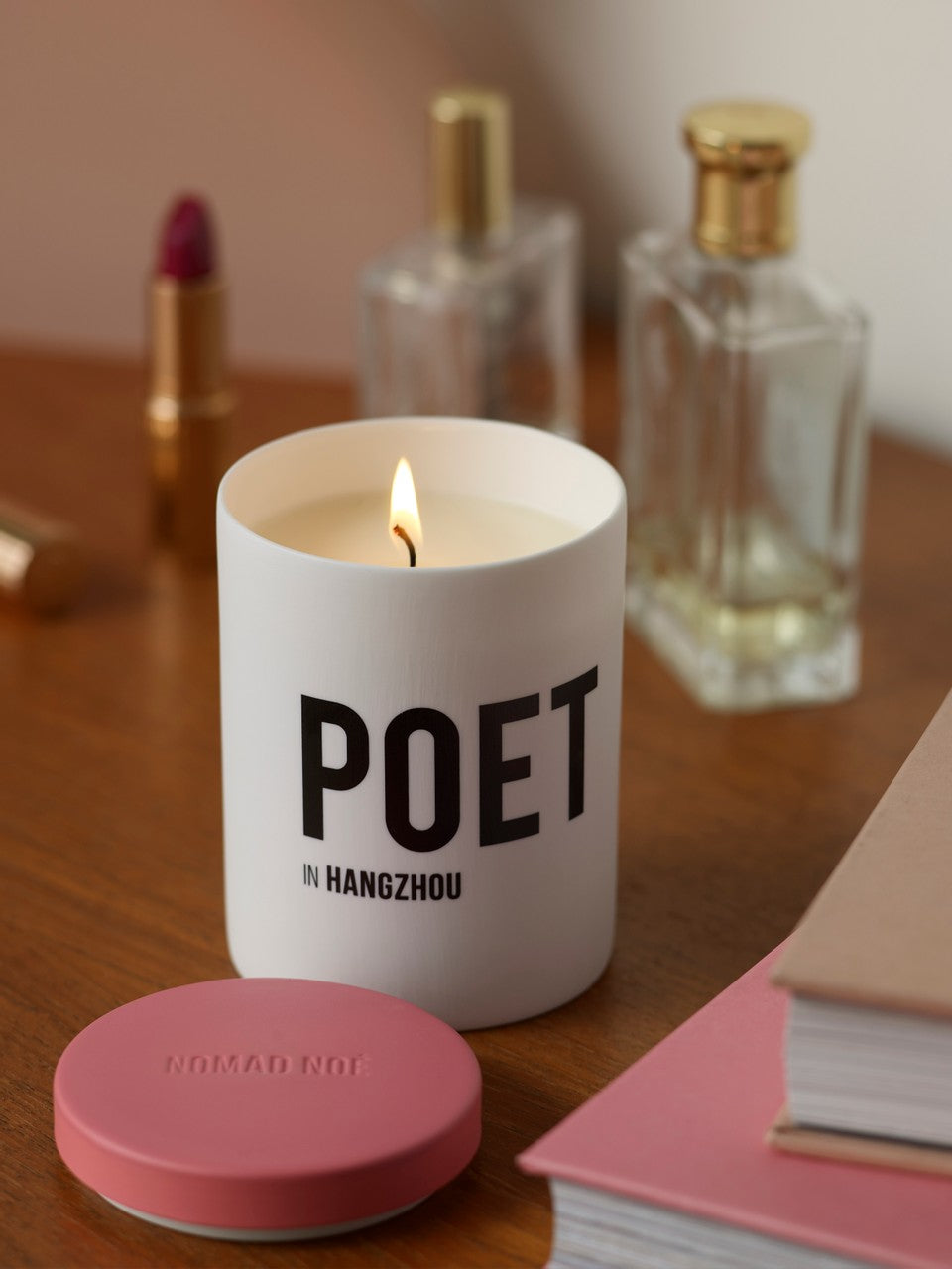 Poet luxury pink scented candle burning 