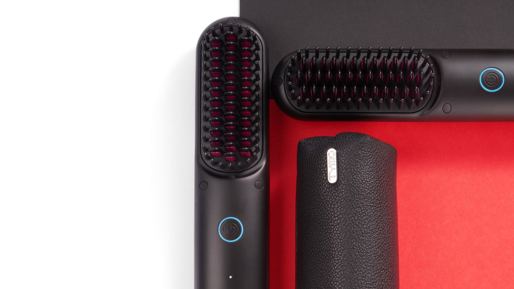 Two cordless hair straightener brushes with black and red design on a minimalist background.