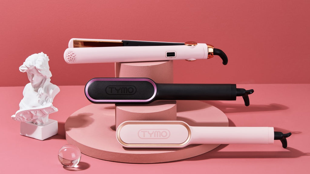 Elegant display of diverse types of hair straighteners, including a flat iron and a brush iron, for various hair styling needs.