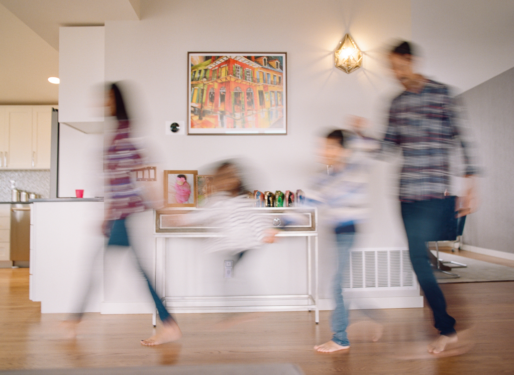 Kim Hildebrand's lifestyle photograph of a family walking through their house