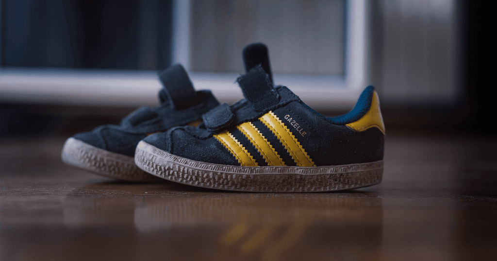 Black and yellow Adidas Gazelle shoes