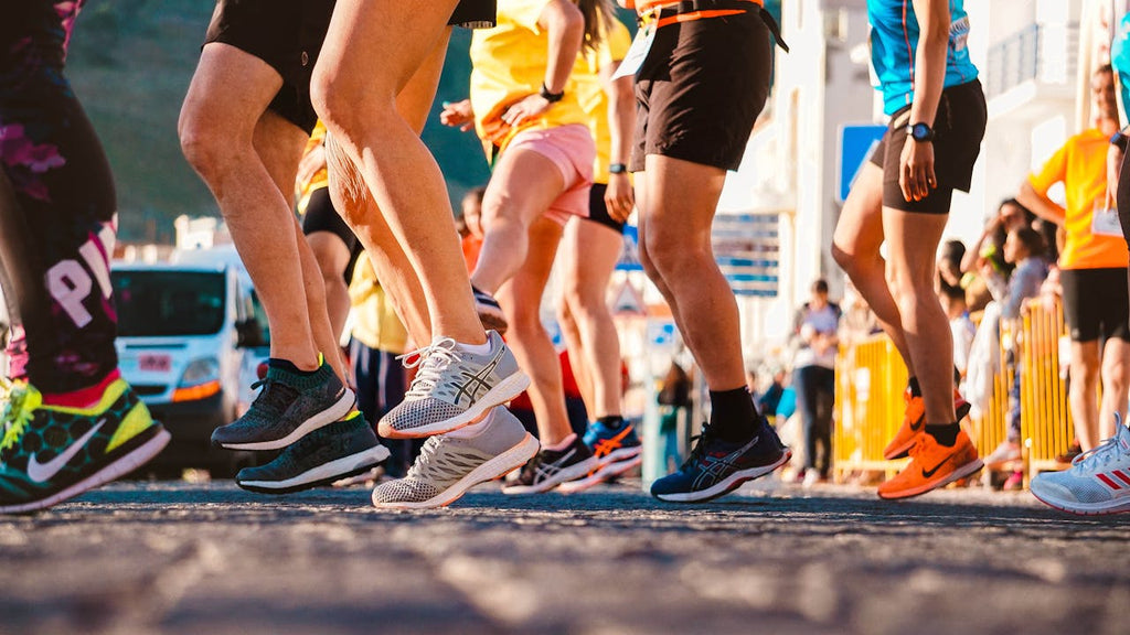 many pair of legs with colorful sneakers