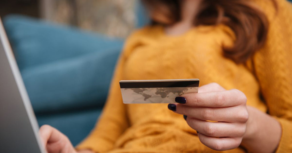 a woman holding a credit card