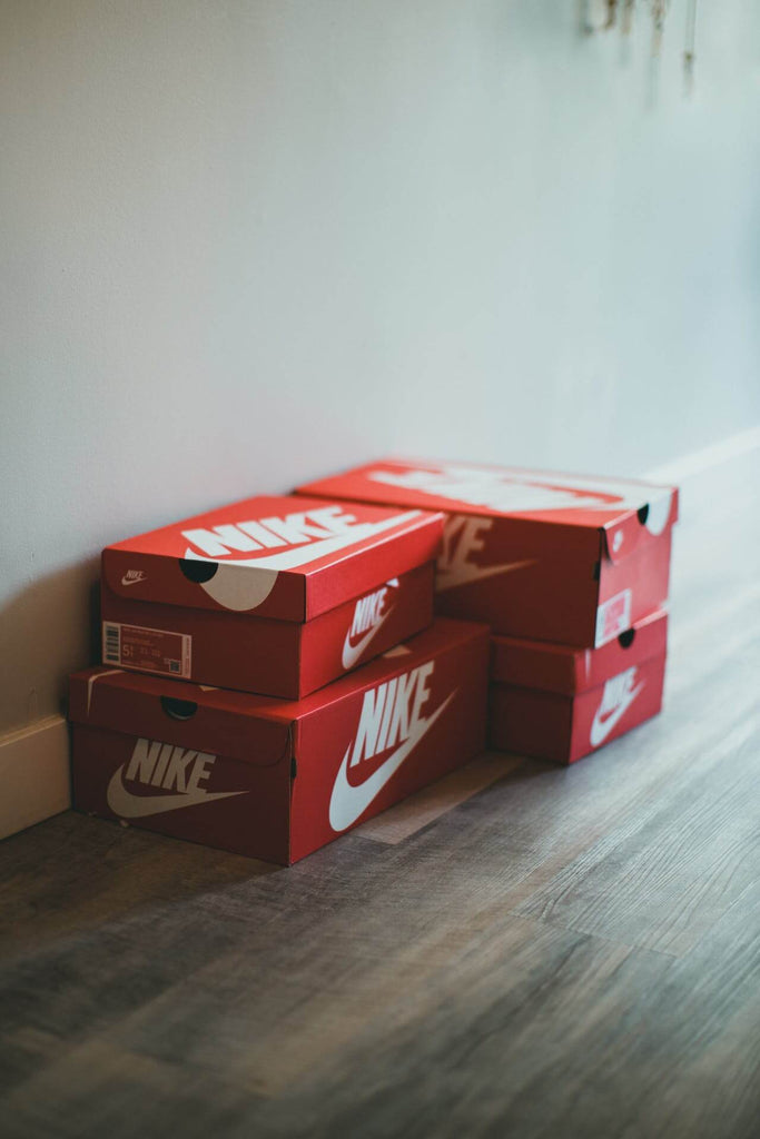 Nike shoe boxes next to a wall
