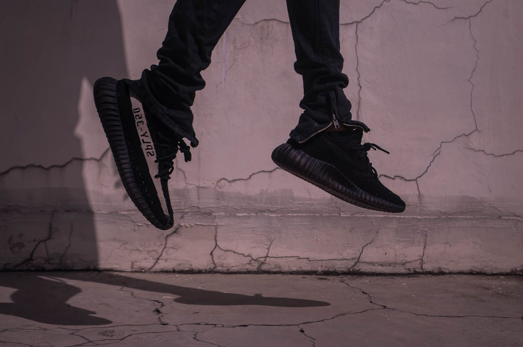 a pair of black and white yeezy sneakers
