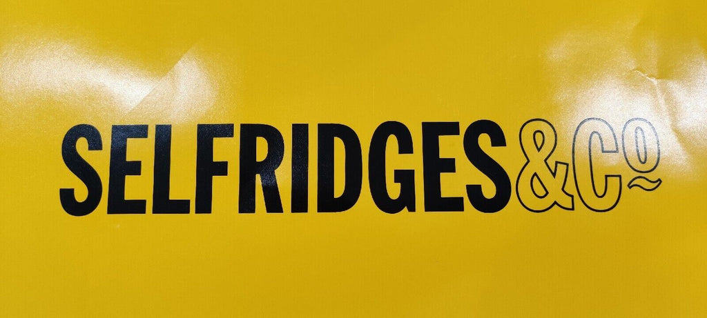 selfridges logo on an yellow background